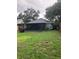Large backyard features a screened in patio and lush green grass, providing ample outdoor space at 6905 Summer Harbor Ln, Riverview, FL 33578