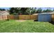 Grassy backyard featuring a new wooden fence, storage shed, and potential for landscaping and outdoor activities at 6905 Summer Harbor Ln, Riverview, FL 33578