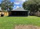 Backyard view showcasing a screened lanai and fenced in yard for privacy and security at 6905 Summer Harbor Ln, Riverview, FL 33578