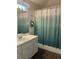 Standard bathroom with a single vanity, mirror, and shower with modern curtain at 6905 Summer Harbor Ln, Riverview, FL 33578