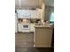Functional kitchen featuring white appliances, ample cabinet space, and dark wood flooring at 6905 Summer Harbor Ln, Riverview, FL 33578