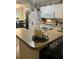Kitchen with white appliances and cabinets with a view into the dining area at 6905 Summer Harbor Ln, Riverview, FL 33578