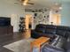 Spacious living room with dark wood flooring, a large sectional couch, and wall decor at 6905 Summer Harbor Ln, Riverview, FL 33578