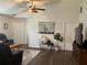 Inviting living room featuring wood floors, ceiling fan, and neutral décor with an abundance of natural light at 6905 Summer Harbor Ln, Riverview, FL 33578