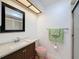 Bathroom features shower with glass door, updated vanity, framed mirror and tile flooring at 8320 High Point Cir # 5, Port Richey, FL 34668