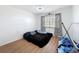 Bedroom with laminate flooring, natural light, and simple decor at 8320 High Point Cir # 5, Port Richey, FL 34668