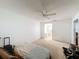 Bright bedroom features neutral carpet, ceiling fan, and ensuite bathroom access at 8320 High Point Cir # 5, Port Richey, FL 34668