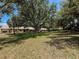 Landscaped exterior featuring mature trees and expansive greenery at 8320 High Point Cir # 5, Port Richey, FL 34668