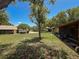 Exterior shot displaying the home's setting with ample yard space and mature trees at 8320 High Point Cir # 5, Port Richey, FL 34668