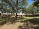 The property is nestled among mature trees with a well-maintained exterior at 8320 High Point Cir # 5, Port Richey, FL 34668