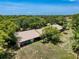 Aerial view of the single-story villa with a lush green lawn and mature palm trees at 8320 High Point Cir # 5, Port Richey, FL 34668