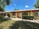 This home features a well-maintained yard, mature bushes, a neutral color scheme, and a sidewalk at 8320 High Point Cir # 5, Port Richey, FL 34668