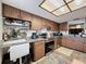 Traditional kitchen featuring wood cabinets, neutral countertops, and stainless steel appliances at 8320 High Point Cir # 5, Port Richey, FL 34668