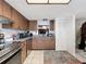 Efficient kitchen features wood cabinetry, granite countertops, stainless steel appliances, and an attractive light fixture at 8320 High Point Cir # 5, Port Richey, FL 34668