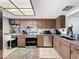 Functional kitchen with wood cabinets, stainless steel appliances, granite countertops, and a multi colored area rug at 8320 High Point Cir # 5, Port Richey, FL 34668