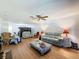 Open-concept living room with wood floors, ceiling fan, and comfortable seating at 8320 High Point Cir # 5, Port Richey, FL 34668