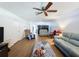 Comfortable living room with wood floors, ceiling fan, and partition screens at 8320 High Point Cir # 5, Port Richey, FL 34668