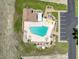 Aerial view of a community pool featuring ample seating and decorative landscaping; parking available at 8320 High Point Cir # 5, Port Richey, FL 34668
