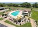 Community pool with lounge chairs, manicured landscaping, and ample space for relaxation at 8320 High Point Cir # 5, Port Richey, FL 34668