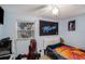 Inviting bedroom with a ceiling fan, natural light, and a comfortable gaming space at 8401 Pinewood St, Tampa, FL 33615