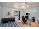 Well-lit bedroom with a gaming chair, computer, and luxury vinyl plank flooring at 8401 Pinewood St, Tampa, FL 33615