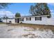 Charming single-story home with fenced yard, front entrance, and basketball hoop, providing comfort and recreation at 8401 Pinewood St, Tampa, FL 33615
