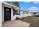 The front of the home is captured from an angle showing the front door, front windows, and an unlandscaped yard at 8401 Pinewood St, Tampa, FL 33615