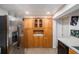 Spacious kitchen features wooden cabinets, stainless steel refrigerator, and efficient appliances at 8401 Pinewood St, Tampa, FL 33615