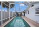 Inviting screened-in pool with crystal clear water offering a refreshing outdoor oasis at 8401 Pinewood St, Tampa, FL 33615
