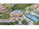 Stunning aerial view showcases the pool, tennis courts, and clubhouse in a meticulously landscaped community setting at 8433 Alberata Vista Dr, Tampa, FL 33647