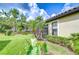Serene backyard featuring lush green lawn, mature trees, and meticulously maintained landscaping at 8433 Alberata Vista Dr, Tampa, FL 33647