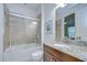 Bathroom featuring a shower-tub combo, granite countertop, and dark wood vanity at 8433 Alberata Vista Dr, Tampa, FL 33647