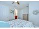 Cozy bedroom with a decorative wreath, dresser, and a glimpse into the bathroom at 8433 Alberata Vista Dr, Tampa, FL 33647