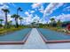 Outdoor bocce ball court surrounded by lush landscaping and palm trees at 8433 Alberata Vista Dr, Tampa, FL 33647