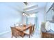 Dining area features a modern chandelier, side board and large format tile floor at 8433 Alberata Vista Dr, Tampa, FL 33647