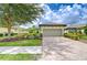 Charming home featuring a tile roof, two-car garage, brick paver driveway, and well-maintained landscaping at 8433 Alberata Vista Dr, Tampa, FL 33647