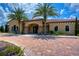 Inviting building features stone accents, arched windows, and lush landscaping, enhancing curb appeal at 8433 Alberata Vista Dr, Tampa, FL 33647