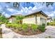 Charming home featuring a tile roof, two-car garage, brick paver driveway, and manicured landscaping at 8433 Alberata Vista Dr, Tampa, FL 33647
