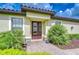 Inviting front entrance featuring a double door, manicured landscaping, and brick paver walkway at 8433 Alberata Vista Dr, Tampa, FL 33647