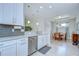 Stylish kitchen with stainless steel appliances, light granite countertops and white cabinetry at 8433 Alberata Vista Dr, Tampa, FL 33647