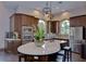 A stylish kitchen features stainless steel appliances, a center island, and custom cabinetry at 8433 Alberata Vista Dr, Tampa, FL 33647