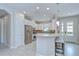 Open kitchen with stainless appliances, breakfast bar seating and white cabinets at 8433 Alberata Vista Dr, Tampa, FL 33647
