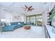 Open concept living room with large couch, and screened porch with grill visible at 8433 Alberata Vista Dr, Tampa, FL 33647