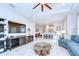 Spacious living room featuring tiled floors, ceiling fan, and modern entertainment center at 8433 Alberata Vista Dr, Tampa, FL 33647