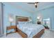 Charming primary bedroom features light blue walls, a ceiling fan and ensuite bathroom at 8433 Alberata Vista Dr, Tampa, FL 33647