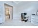 Bright office featuring a desk, ergonomic chair, tiled flooring, and access to the bathroom at 8433 Alberata Vista Dr, Tampa, FL 33647