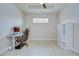 Bright office featuring a desk, ergonomic chair, tiled flooring, and a large window at 8433 Alberata Vista Dr, Tampa, FL 33647