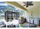 Spacious outdoor kitchen features a grill, stainless steel appliances, bar seating, and screened enclosure at 8433 Alberata Vista Dr, Tampa, FL 33647