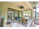 Outdoor kitchen featuring built-in grill, sink, stainless steel appliances, and ceiling fan at 8433 Alberata Vista Dr, Tampa, FL 33647