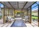 Inviting outdoor space featuring a covered patio, a grill, and comfortable seating arrangement at 8433 Alberata Vista Dr, Tampa, FL 33647
